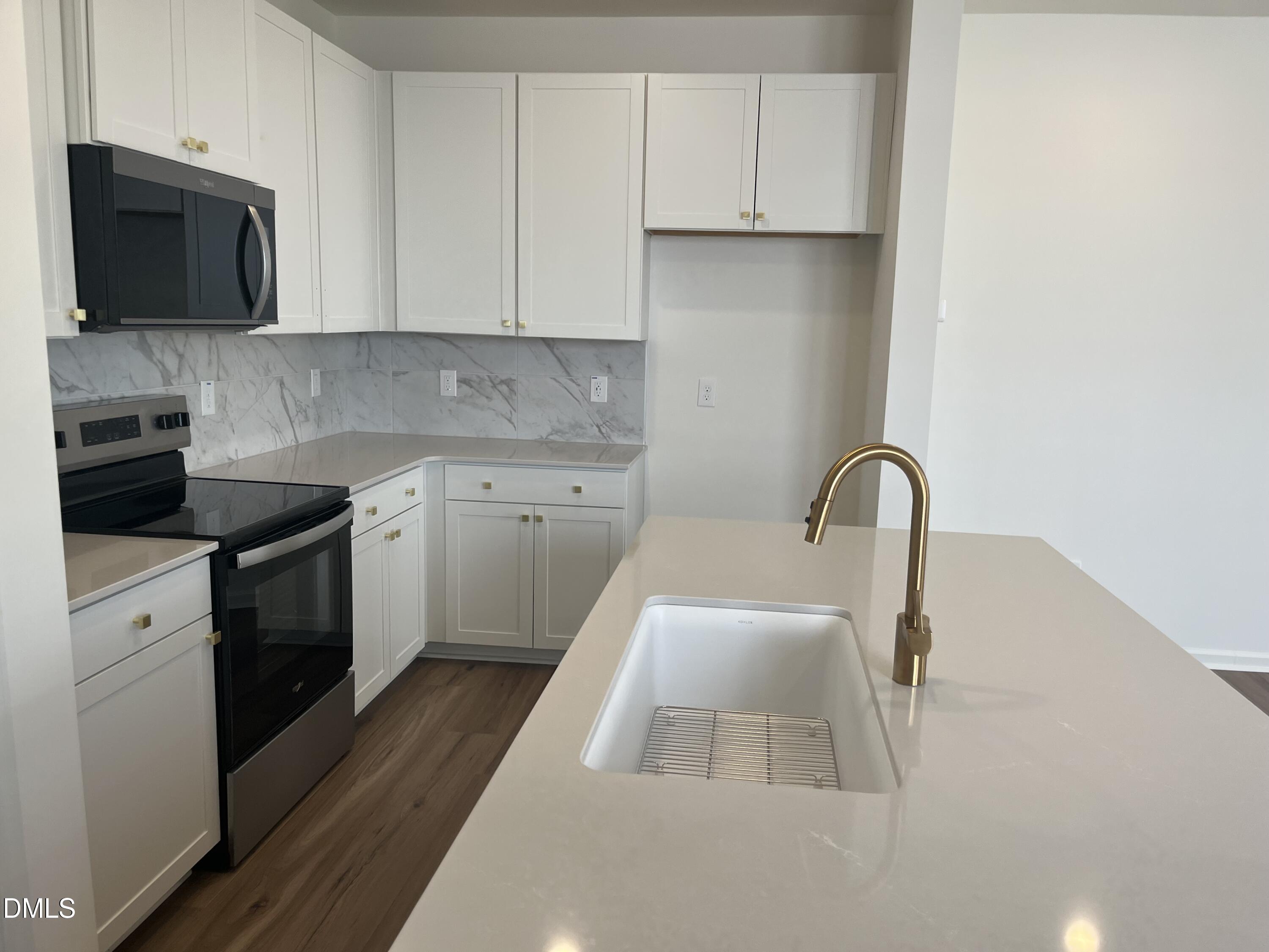 3015 Chrys Street Durham, NC 27704 - Photo 2 of 12 a kitchen with a sink a stove and cabinets