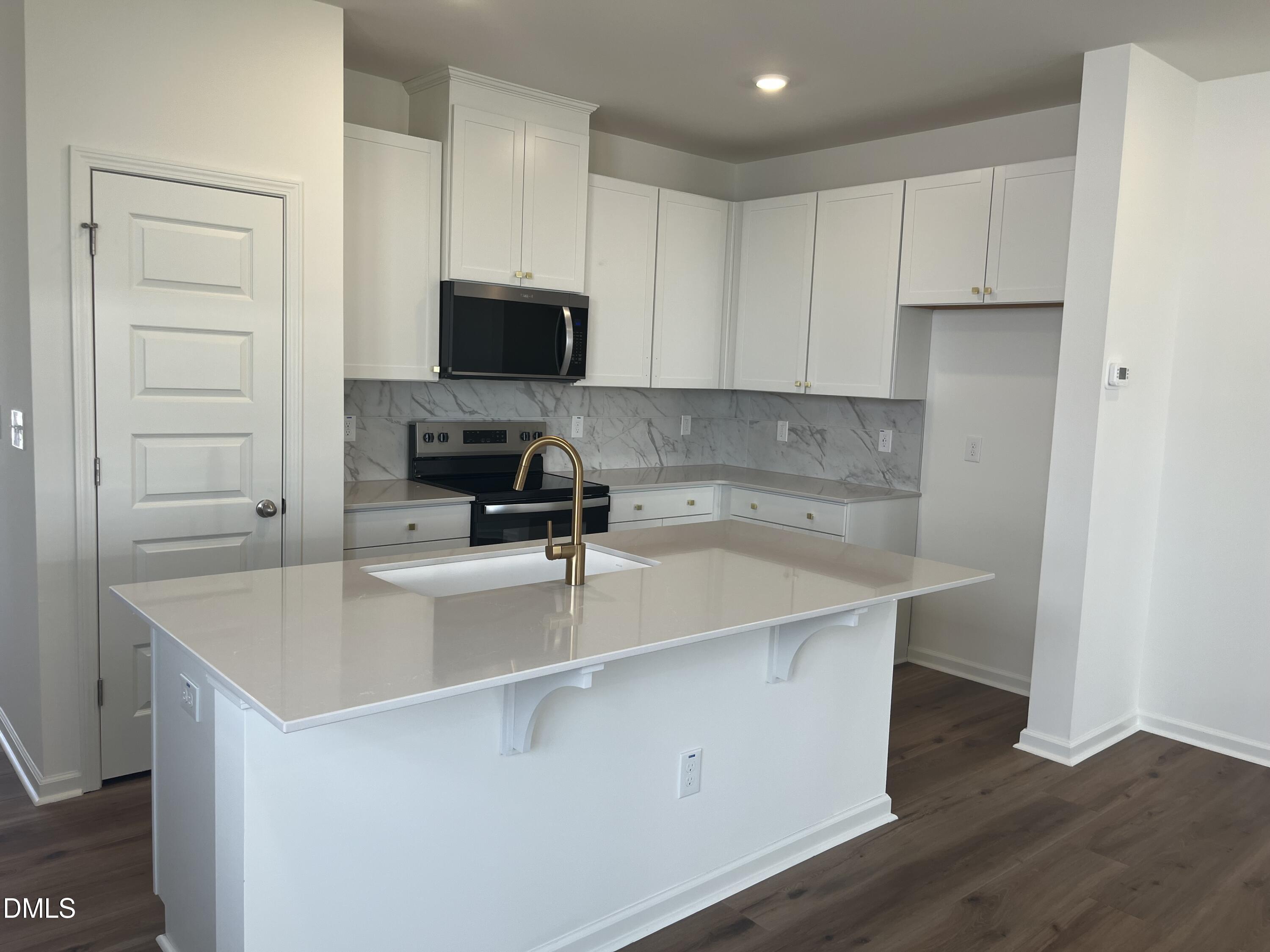 3015 Chrys Street Durham, NC 27704 - Photo 3 of 12 a kitchen with a sink a stove and cabinets