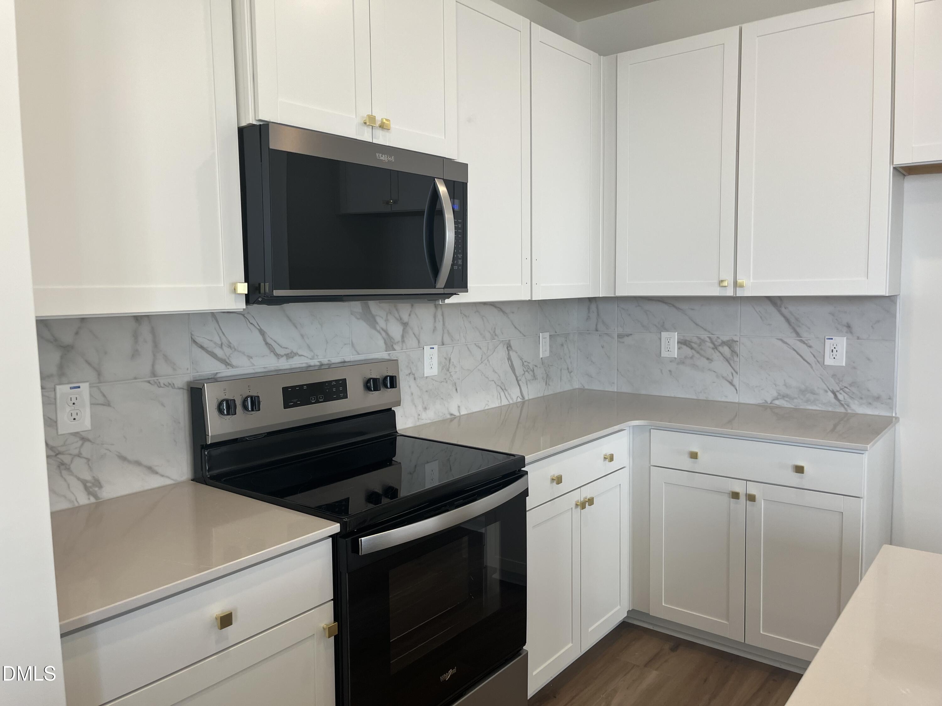 3015 Chrys Street Durham, NC 27704 - Photo 4 of 12 a kitchen with a stove and a microwave