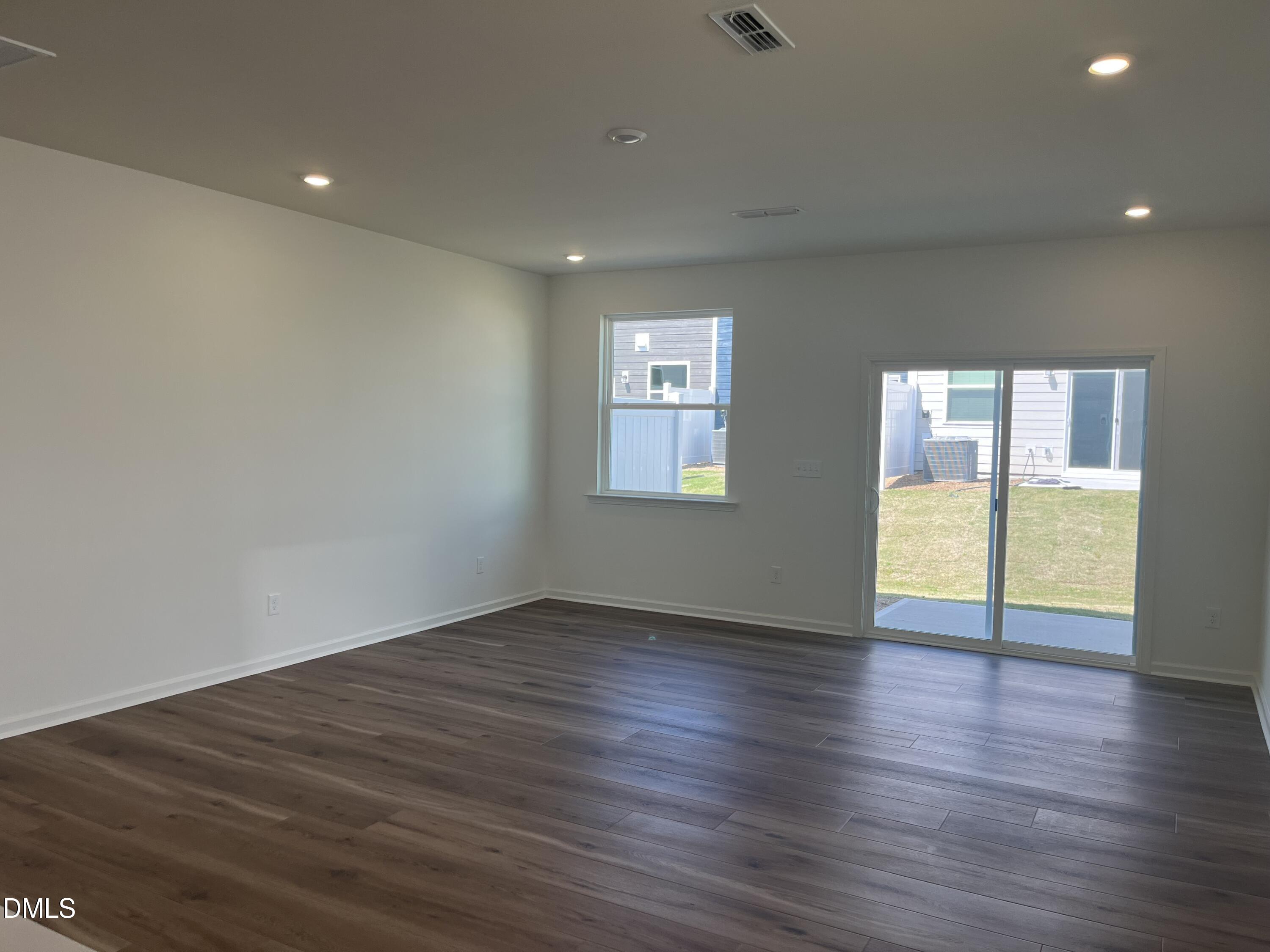 3015 Chrys Street Durham, NC 27704 - Photo 5 of 12 a view of an empty room with wooden floor and a window