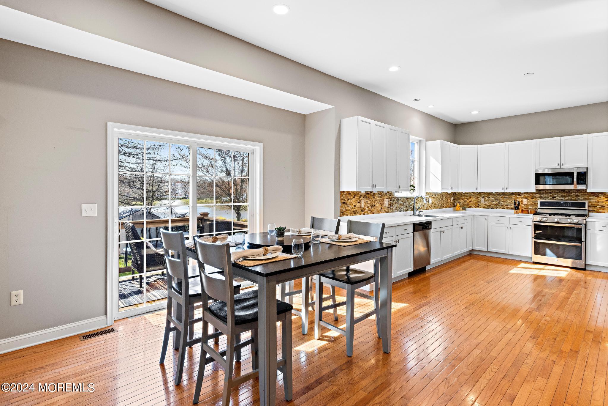 25 Firestone Drive Howell, NJ 07731 - Photo 12 of 65 a view of a dining room with furniture and wooden floor