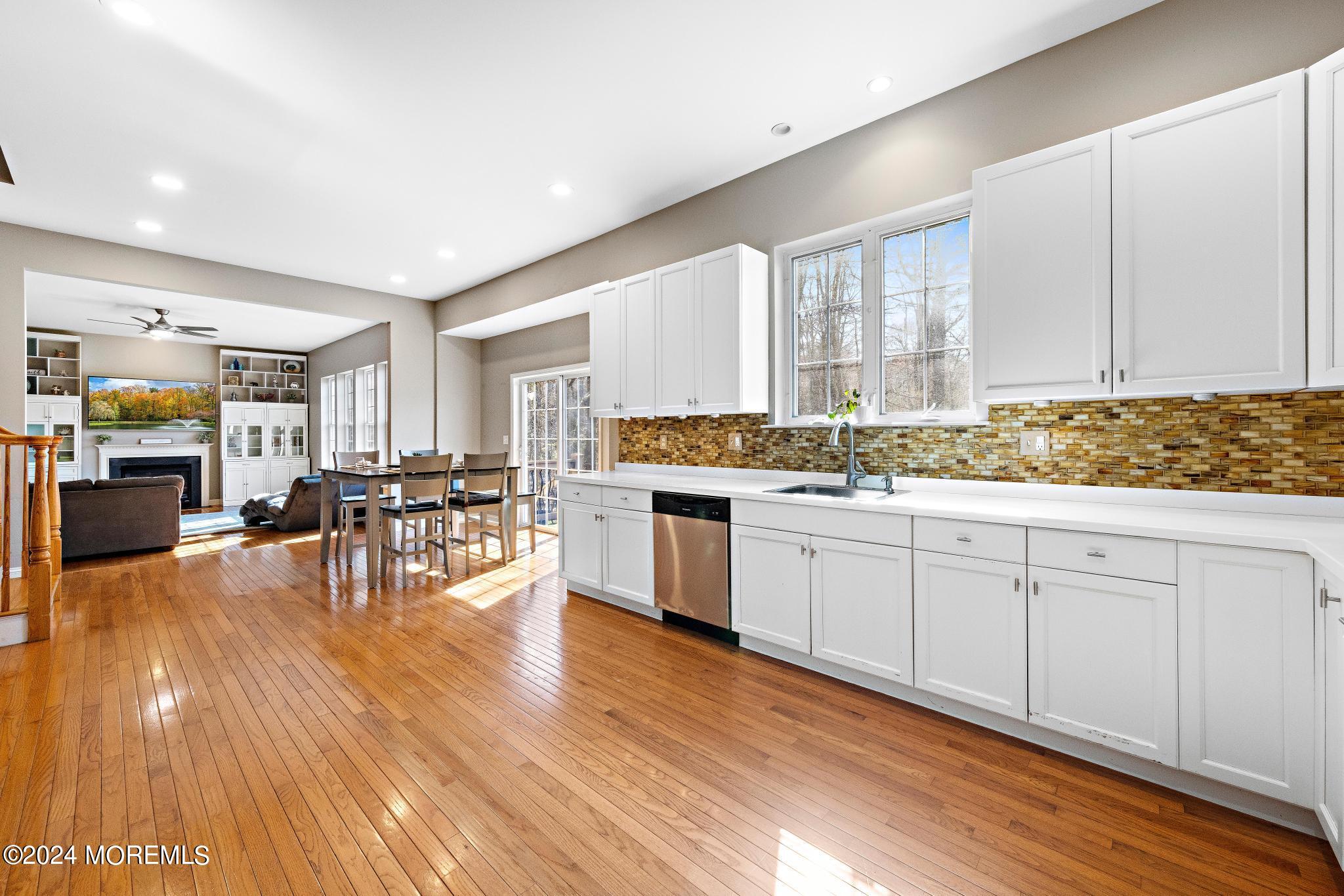 25 Firestone Drive Howell, NJ 07731 - Photo 15 of 65 a open kitchen with white cabinets wooden floor and stainless steel appliances