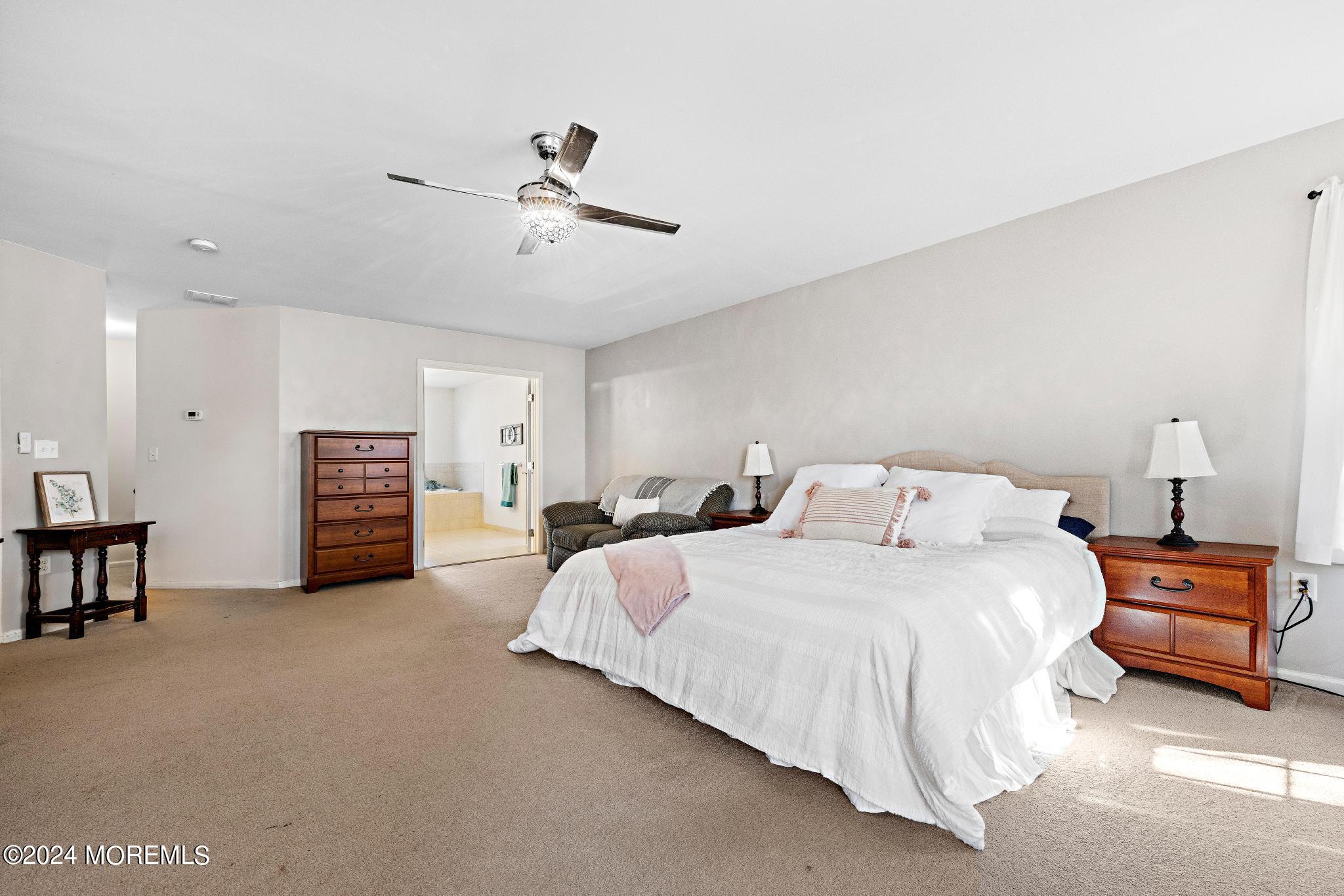 25 Firestone Drive Howell, NJ 07731 - Photo 25 of 65 a bedroom with bed and a chandelier