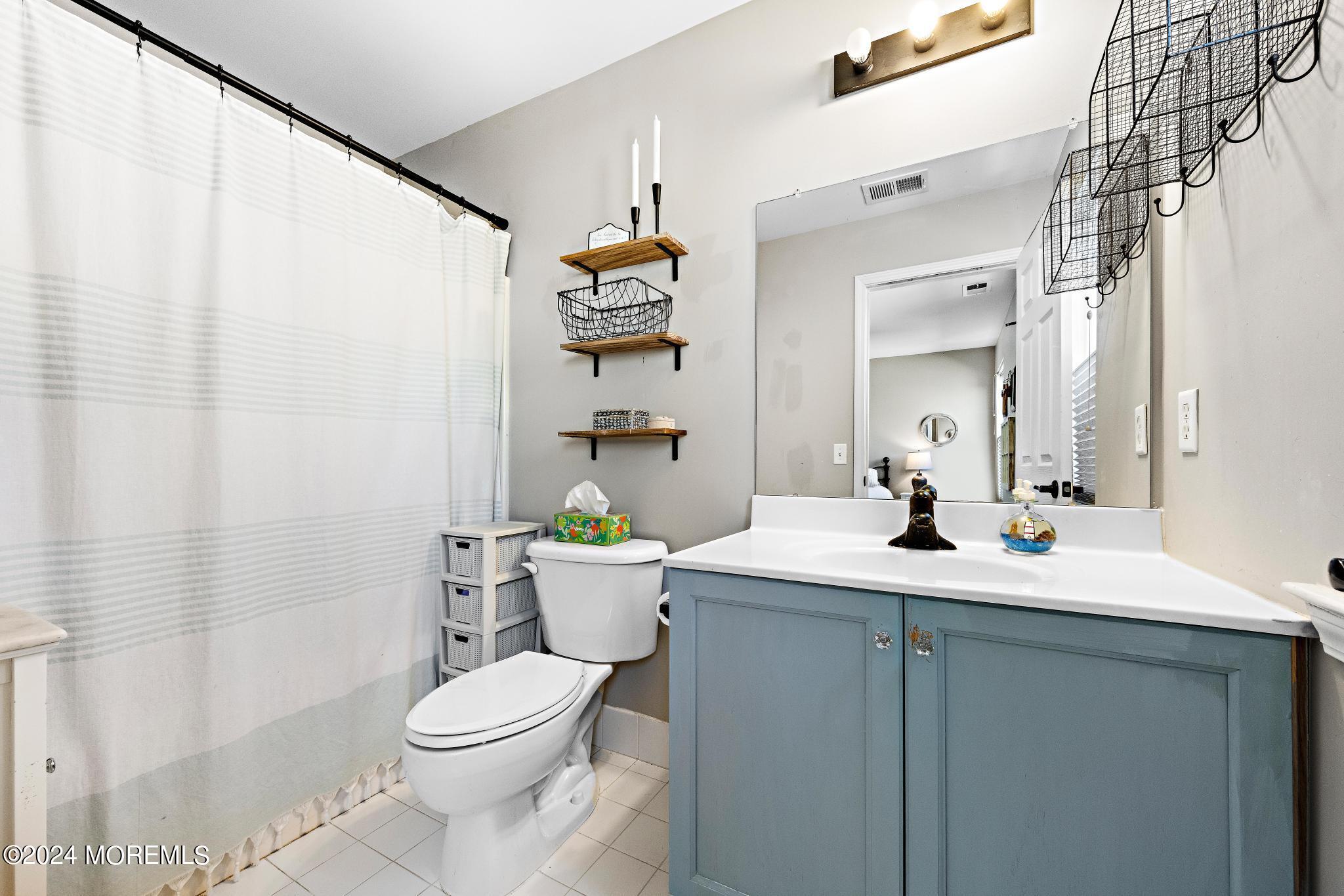 25 Firestone Drive Howell, NJ 07731 - Photo 32 of 65 a bathroom with a toilet a sink and a mirror