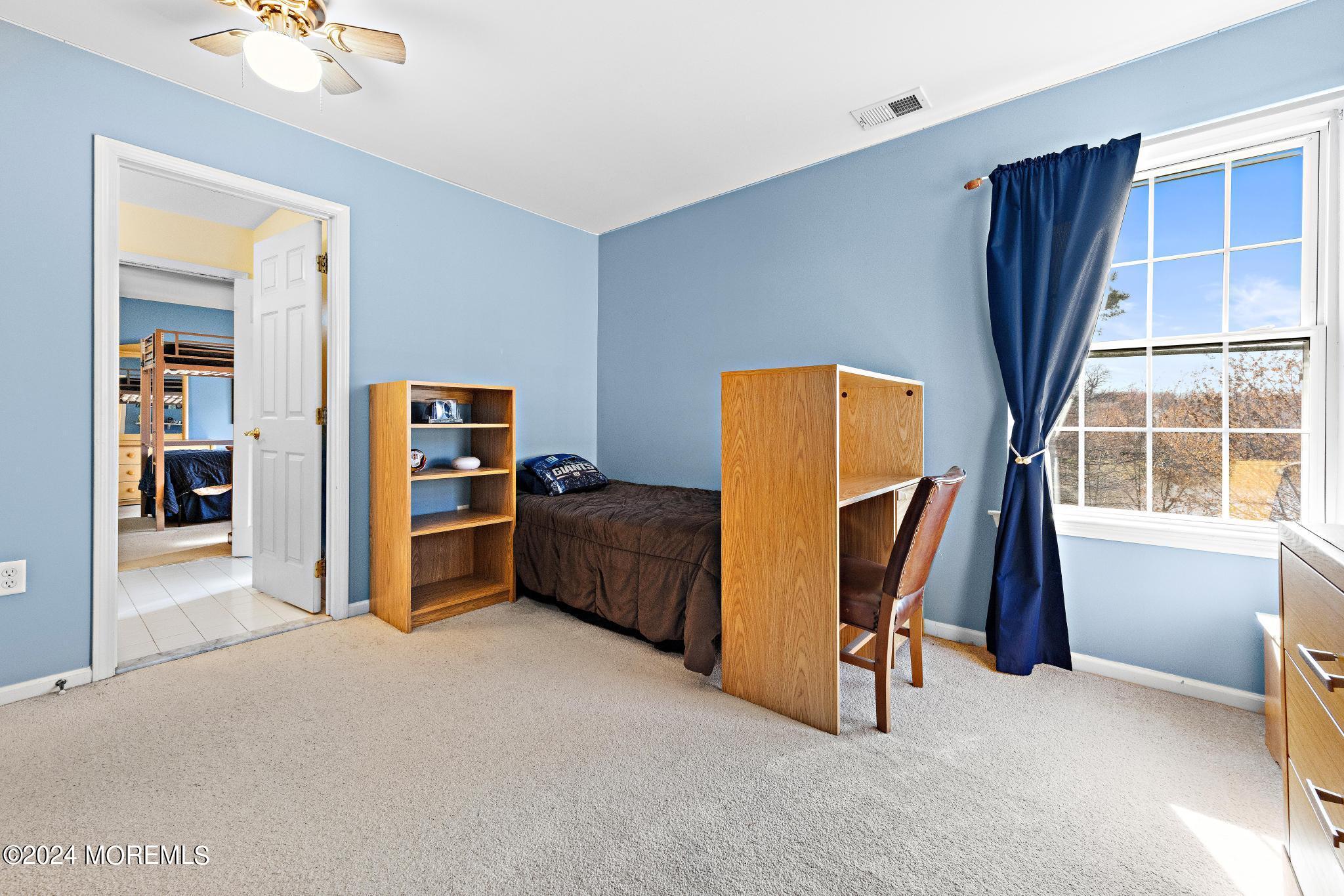 25 Firestone Drive Howell, NJ 07731 - Photo 33 of 65 a view of furniture and refrigerator in a room