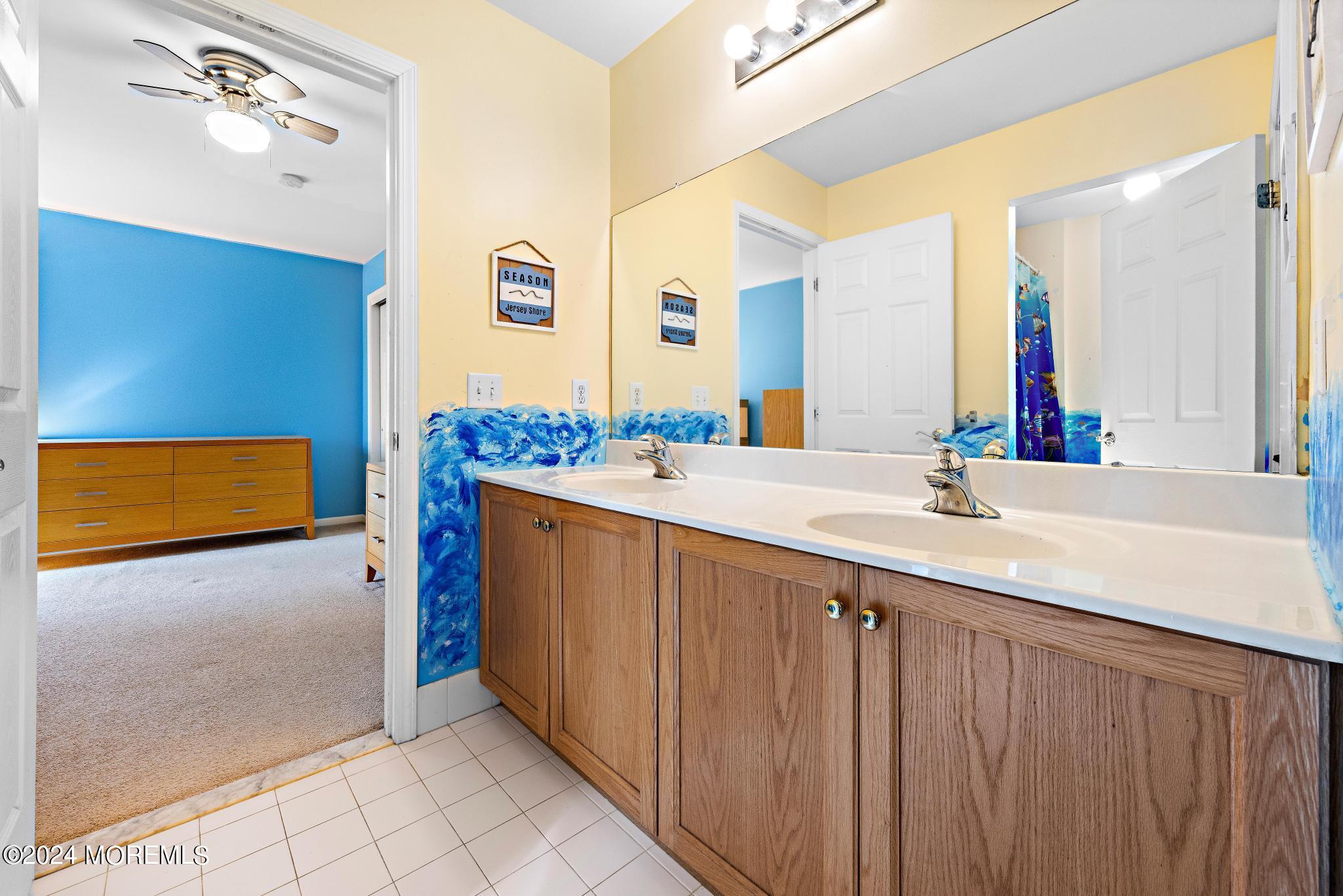 25 Firestone Drive Howell, NJ 07731 - Photo 34 of 65 a bathroom with a double vanity sink a mirror and a