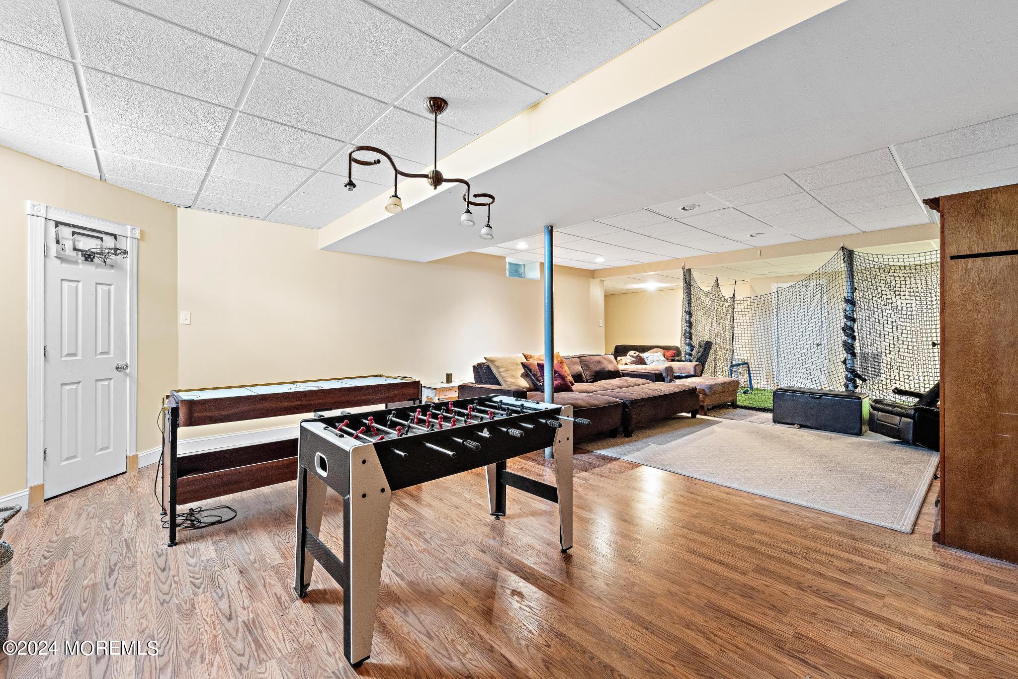 25 Firestone Drive Howell, NJ 07731 - Photo 37 of 65 a living room with furniture and a wooden floor