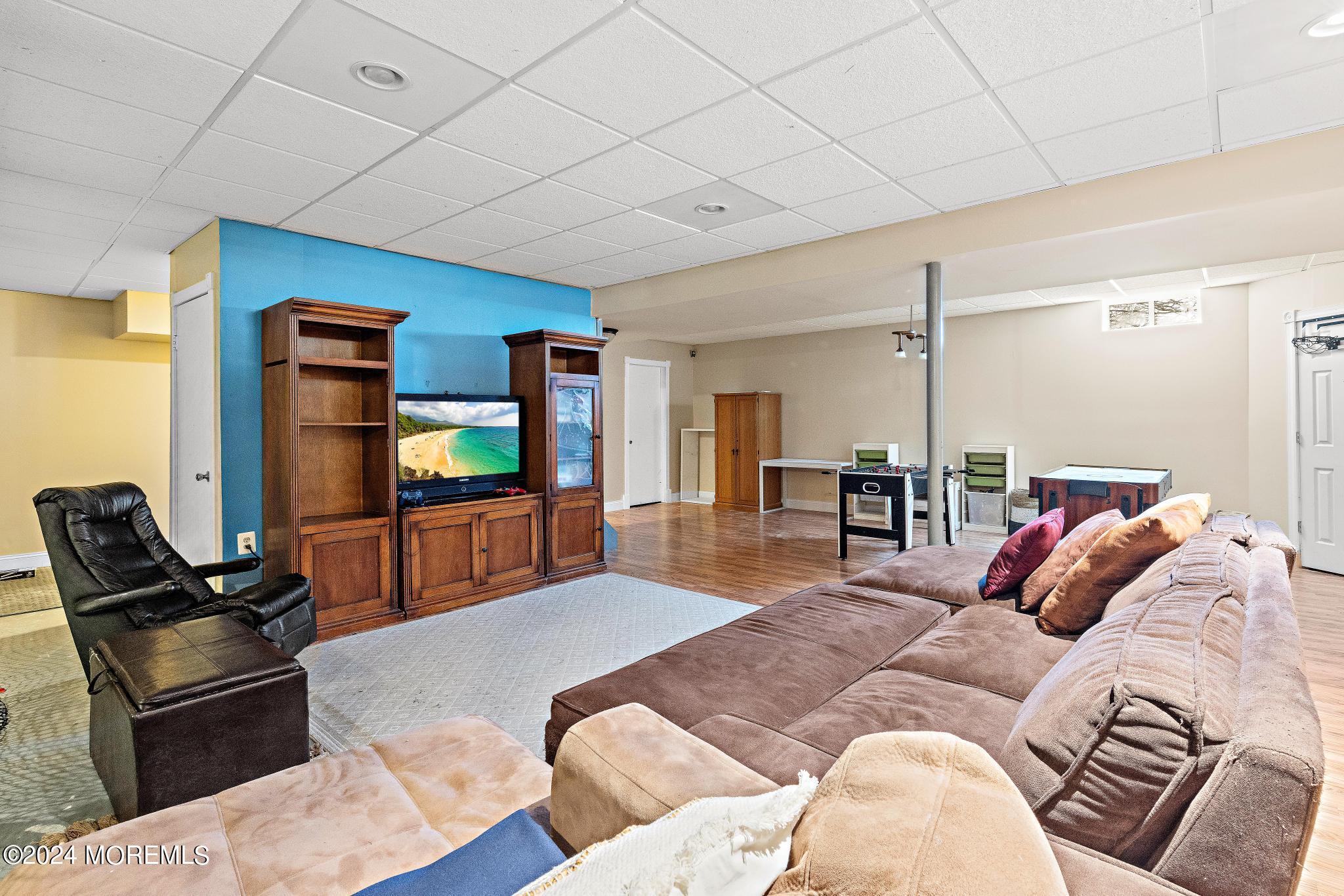 25 Firestone Drive Howell, NJ 07731 - Photo 39 of 65 a living room with furniture and a flat screen tv