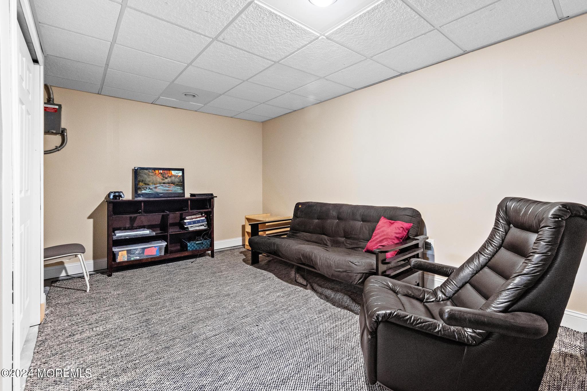 25 Firestone Drive Howell, NJ 07731 - Photo 40 of 65 a living room with furniture and a flat screen tv