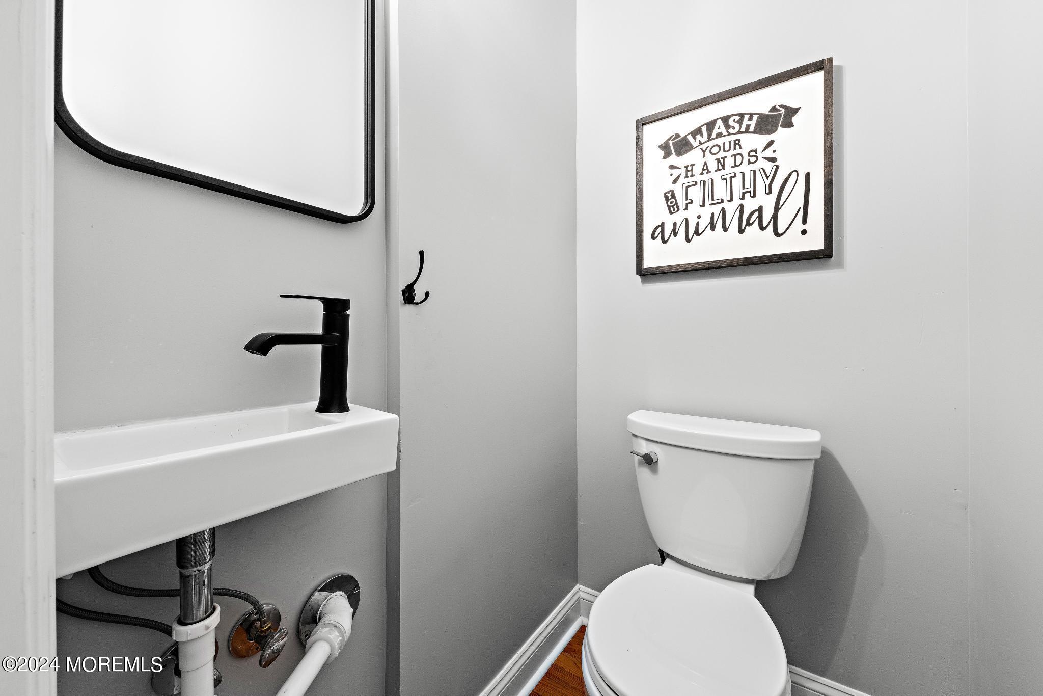 25 Firestone Drive Howell, NJ 07731 - Photo 42 of 65 a bathroom with a toilet and a sink