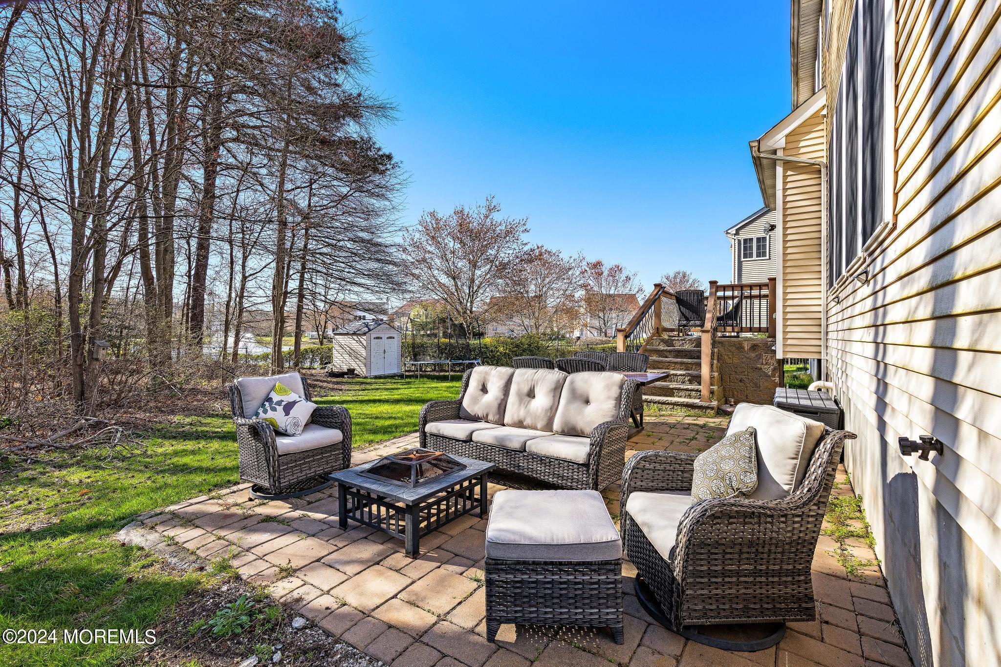 25 Firestone Drive Howell, NJ 07731 - Photo 45 of 65 a view of a patio with couches table and chairs and potted plants with sky view
