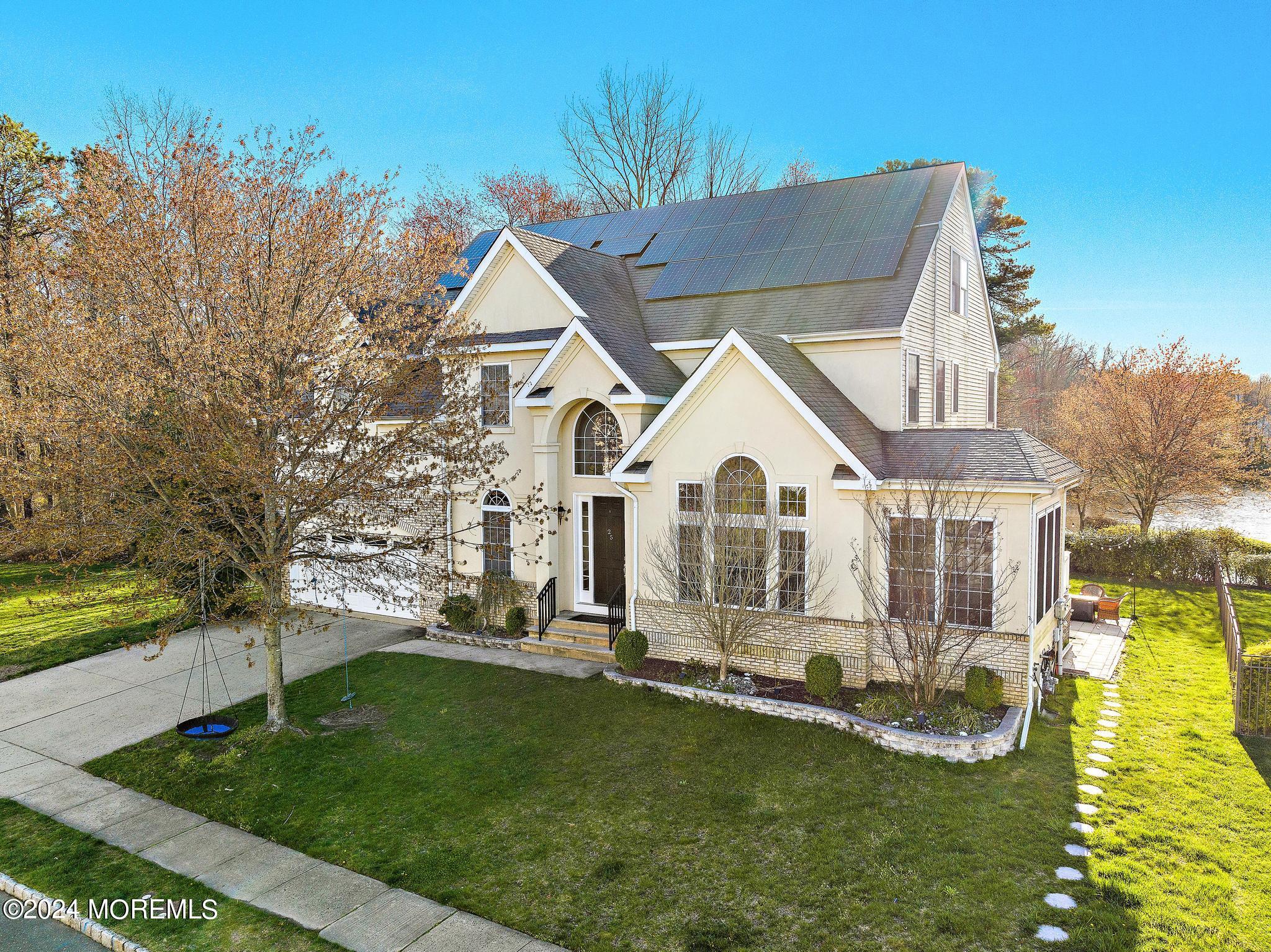 25 Firestone Drive Howell, NJ 07731 - Photo 59 of 65 a front view of a house with a yard table and chairs