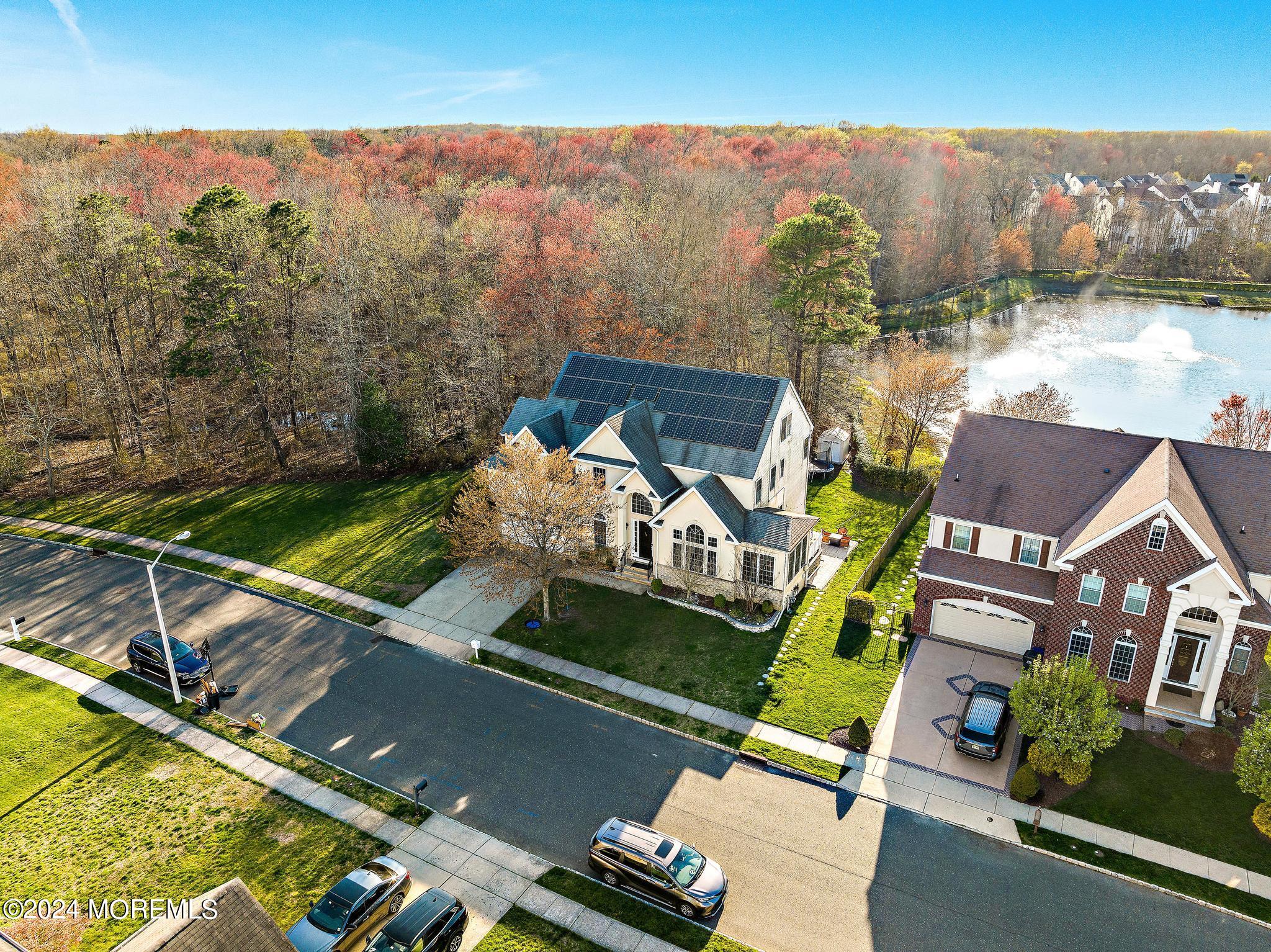 25 Firestone Drive Howell, NJ 07731 - Photo 64 of 65 an aerial view of a house with a garden and lake view
