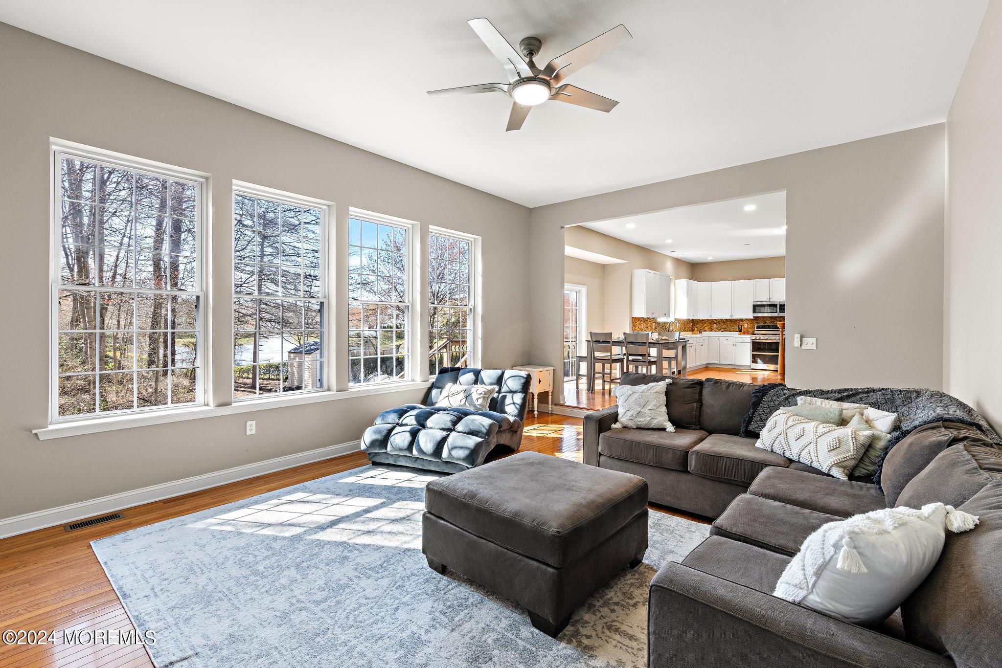 25 Firestone Drive Howell, NJ 07731 - Photo 9 of 65 a living room with furniture and a large window with wooden floor