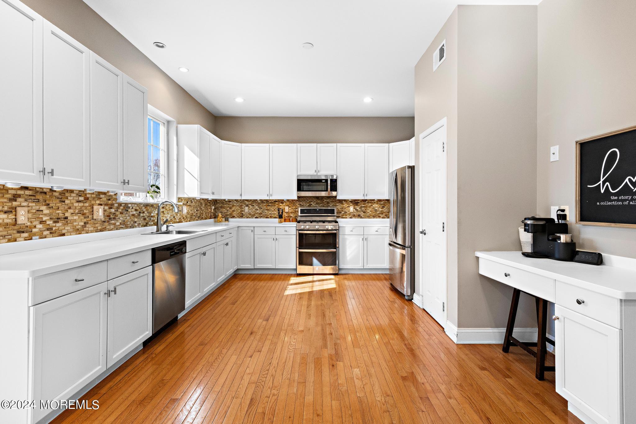 25 Firestone Drive Howell, NJ 07731 - Photo 10 of 65 a kitchen with granite countertop a refrigerator stove top oven and sink