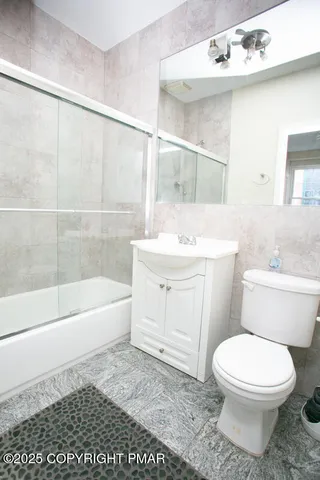 a bathroom with a sink a toilet and bathtub