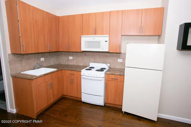 a kitchen with a refrigerator and a stove