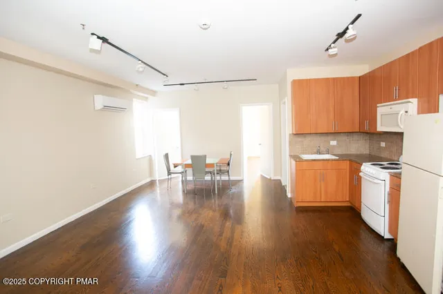 a kitchen with stove and wooden floor