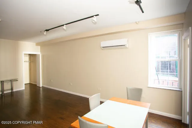 a view of a room with wooden floor and a window