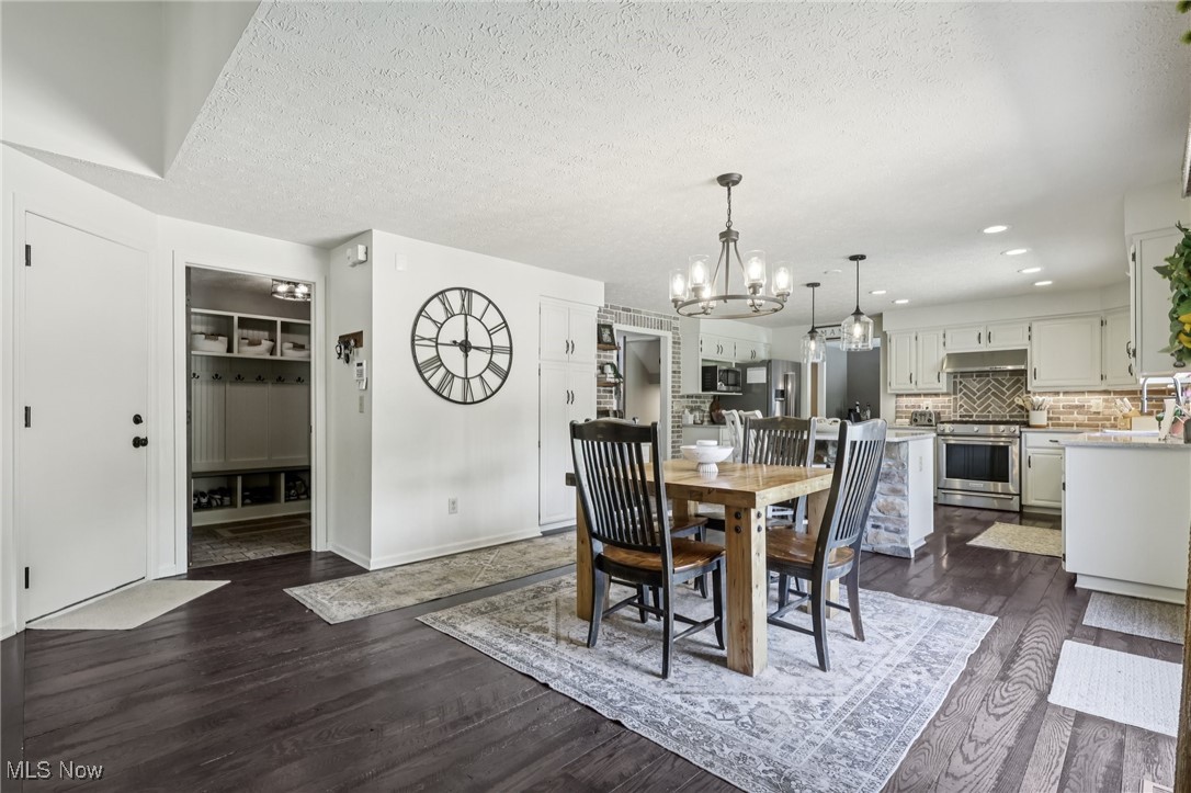 230 South Medina Line Road Akron, OH 44321 - Photo 11 of 50 Dining room featuring a chandelier, dark wood-type flooring, recessed lighting, and a textured ceiling