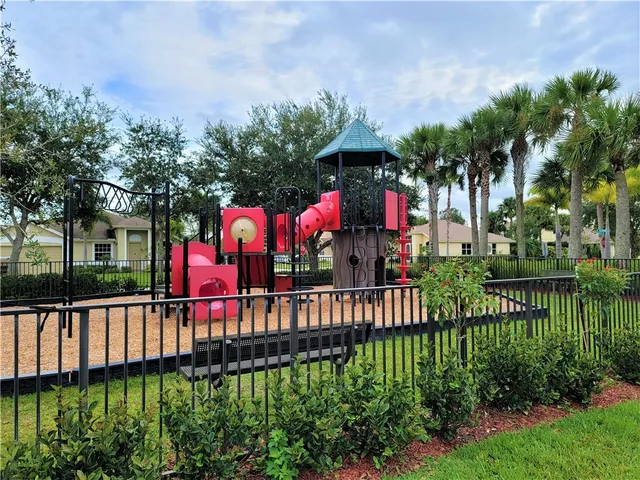 a view of a house with a yard and potted plants