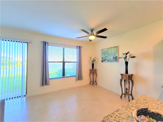 a view of a livingroom with a ceiling fan and window