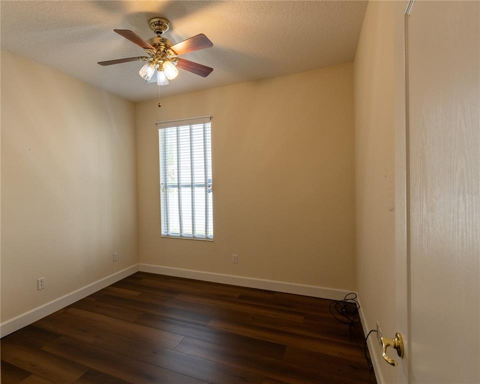65 Calliope Street Ocoee, FL 34761 - Photo 32 of 60 a view of an empty room with wooden floor and a window