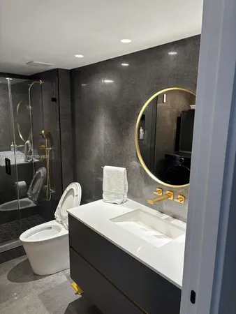 a bathroom with a sink a toilet and mirror