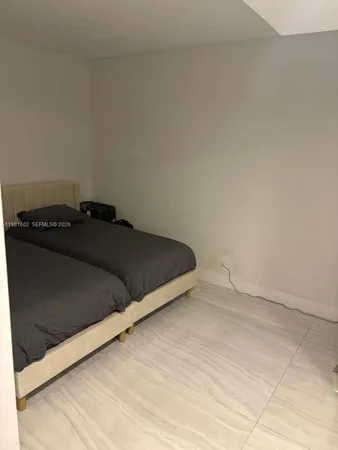 a bedroom with a bed and a night stand