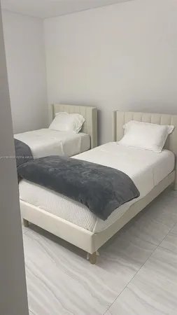 a bedroom with a bed and a lamp