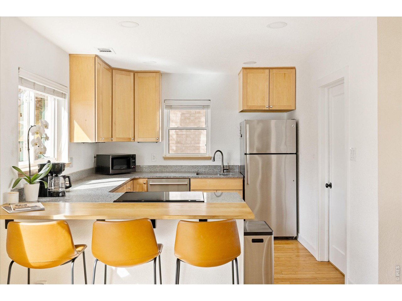 3217 Broadway Boulder, CO 80304 - Photo 7 of 30 a kitchen with a table chairs and a refrigerator