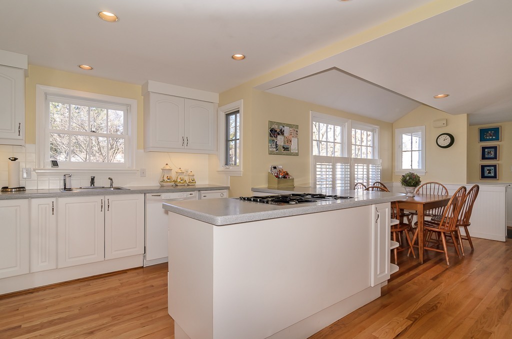 36 Stanford Road Wellesley, MA 02481 - Photo 3 of 22 a kitchen with stainless steel appliances granite countertop a stove top oven a sink a dining table and chairs