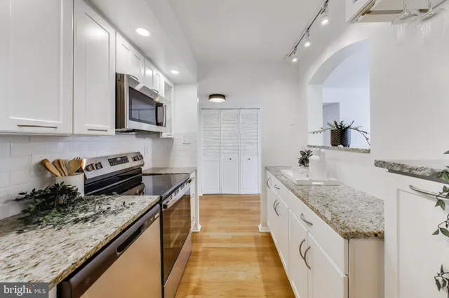 a bedroom with bed and a potted plant