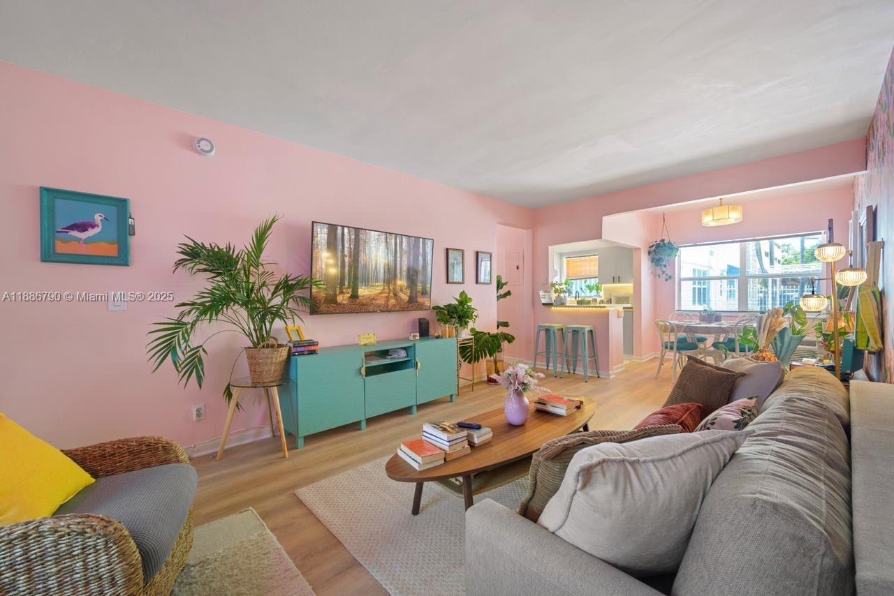 315 Van Buren Street, Unit 104B Hollywood, FL 33019 - Photo 1 of 22 a living room with furniture and a potted plant