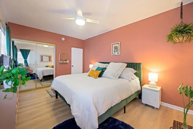 a spacious bedroom with a bed and a potted plant