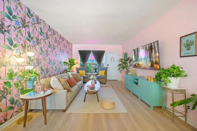 a living room with furniture potted plant and a table