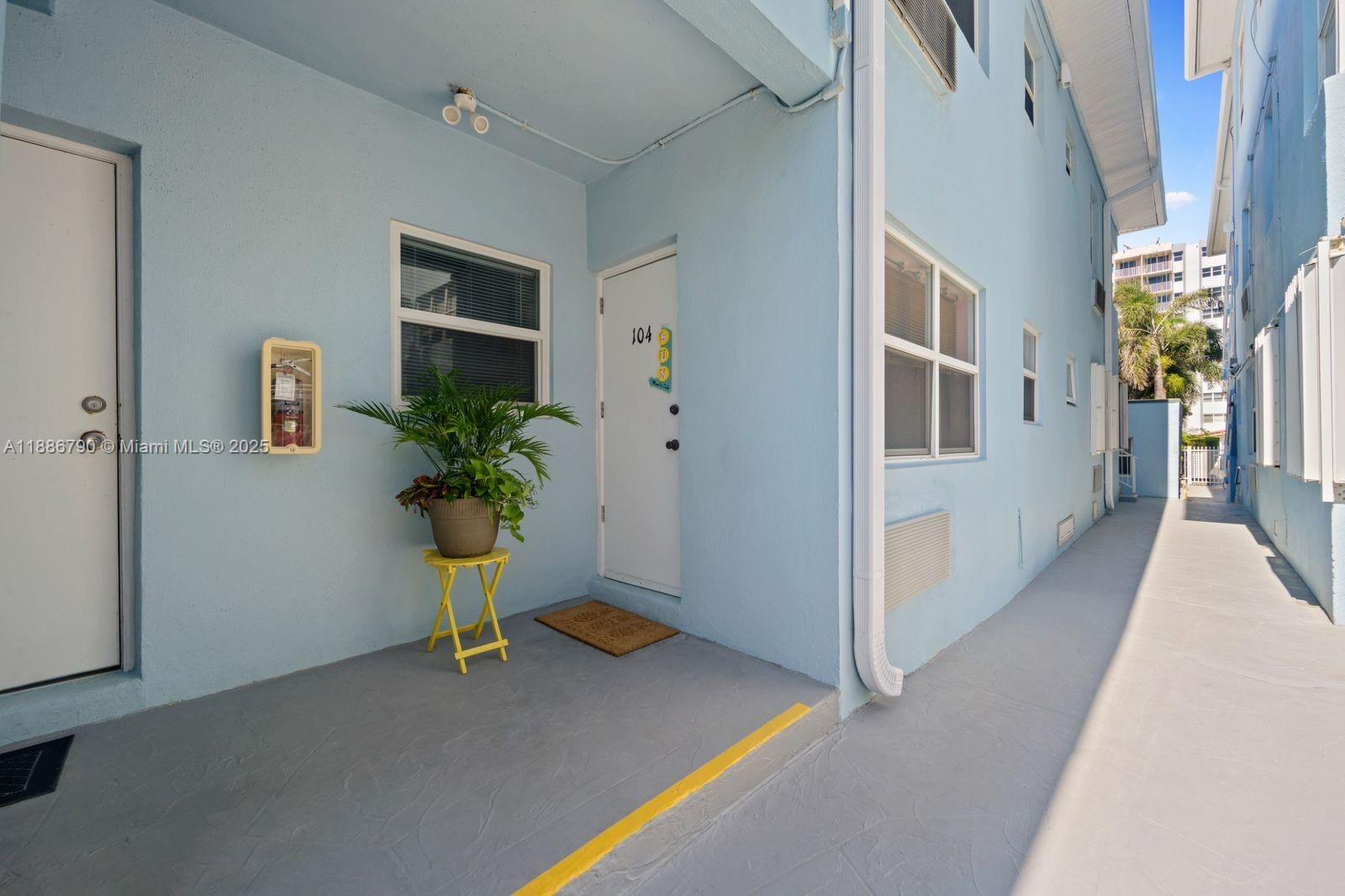 315 Van Buren Street, Unit 104B Hollywood, FL 33019 - Photo 21 of 22 a view of a hallway with windows