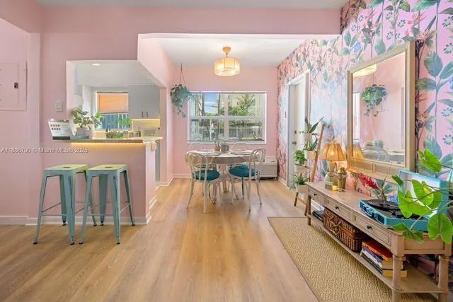 a view of a dining room with furniture a chandelier and wooden floor