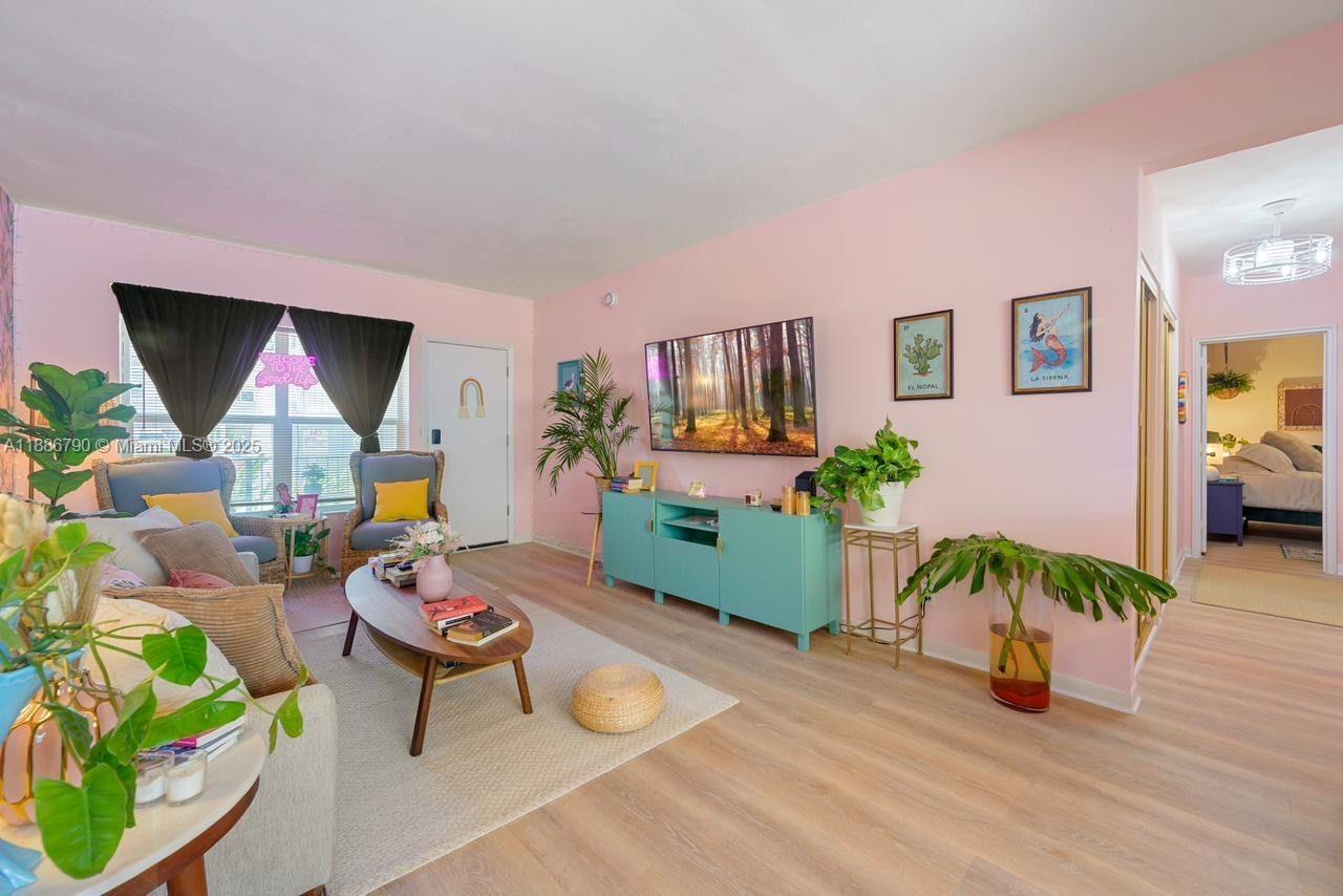 315 Van Buren Street, Unit 104B Hollywood, FL 33019 - Photo 5 of 22 a living room with furniture and a flat screen tv