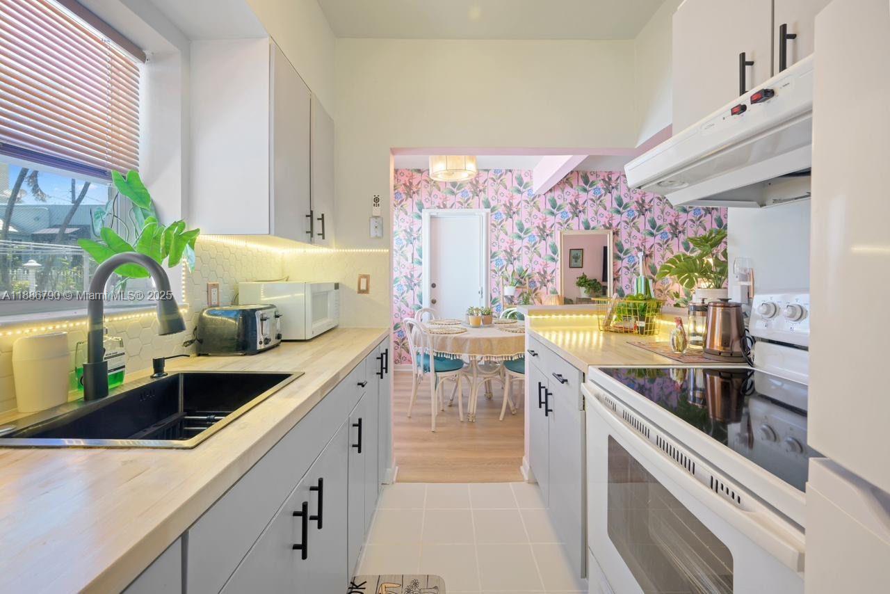 315 Van Buren Street, Unit 104B Hollywood, FL 33019 - Photo 8 of 22 a kitchen with lots of counter top space