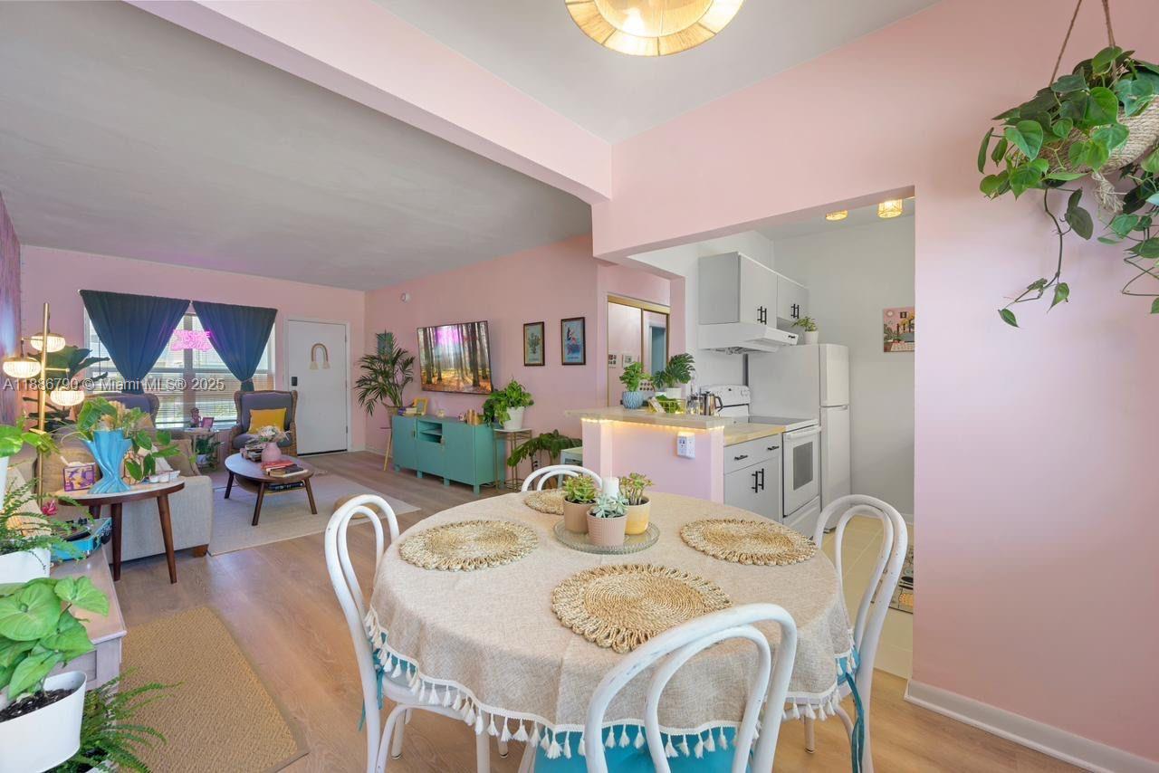 315 Van Buren Street, Unit 104B Hollywood, FL 33019 - Photo 9 of 22 a view of a dining room with furniture and a potted plant
