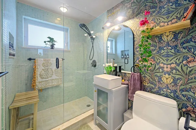 a bathroom with a sink mirror and toilet