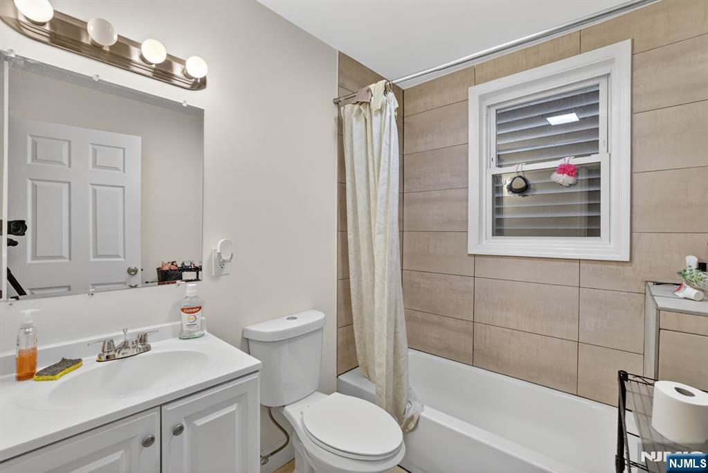 78 Treacy Avenue Newark, NJ 07108 - Photo 16 of 22 a bathroom with a sink a toilet and shower