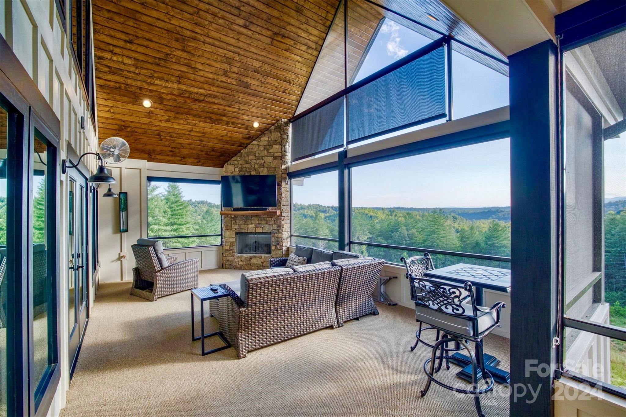 6140 Painted Rdg Trail Lenoir, NC 28645 - Photo 13 of 47 a living room with furniture tv and a floor to ceiling window