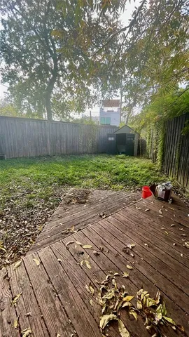 a view of backyard of house with green space