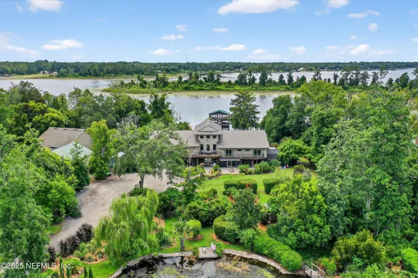 an aerial view of a house with yard swimming pool and outdoor seating