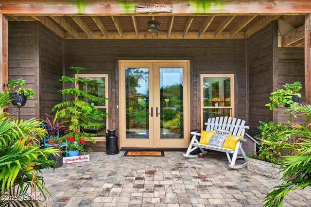 a spacious bedroom with a bed and a chandelier
