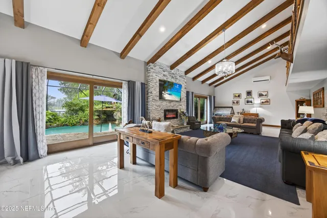 an aerial view of a house with a yard and lake view