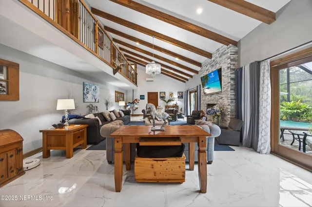 a front view of a house with a yard and potted plants