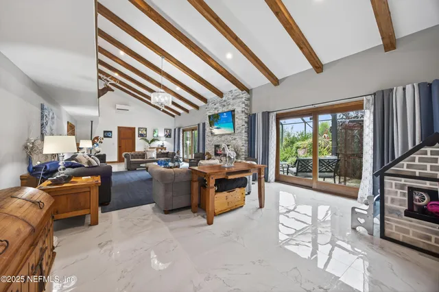 an aerial view of a residential houses with outdoor space and lake view